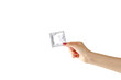 © OB production - Girl's hand holding a single condom. Close up. Isolated on white background