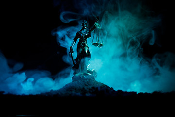 The Statue of Justice - lady justice or Iustitia / Justitia the Roman goddess of Justice on a dark fire background