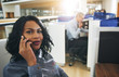 © Flamingo Images - Pretty black office employee sitting and talking smartphone