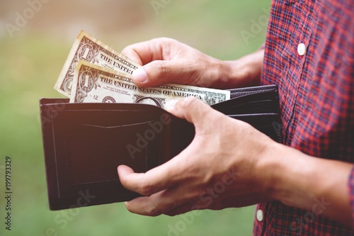 Fotografía Business Person holding an wallet in the hands of an man no money have a little money