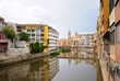 Colorful houses, reflected in the water of the river Onyar. View from the Red iron bridge or Girona Eiffel Bridge (Pont de les Peixateries velles). The historic Jewish quarter in Girona, Spain. 
