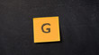 © stryjek - Sticky note with letter 'G' on the blackboard