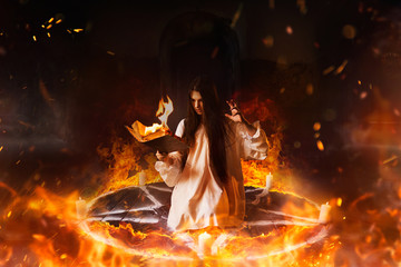 Wall Mural - Woman sitting in burning pentagram circle, magic