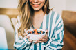 © DavidPrado - Crop woman close up eating oat and fruits bowl for breakfast