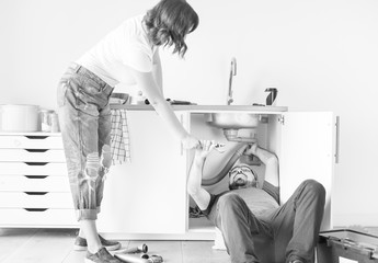 Wall Mural - Couple fixing kitchen sink