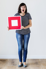 Wall Mural - Caucasian woman holding a red stop icon