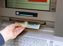 Boy Withdraws Money From An ATM With Euro Currency