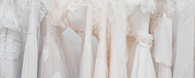 Banner White Modern Wedding Dresses In Dress Store.