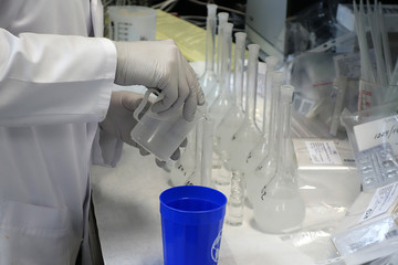 A working day in chemical laboratory: a assistant prepares samples for analysis