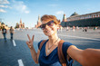 Beautiful young woman girl hipster makes selfie on Red Square in Moscow, Travel to Russia