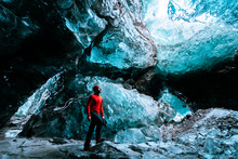 Adventurer Inside A Blue Ice Cave In Iceland