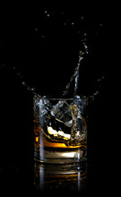 Splash Of Ice In Glass Of Whiskey