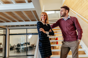 Wall Mural - Shot of two colleagues standing in an office building