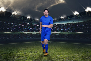 Wall Mural - Handsome asian football player playing football