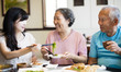 © Tom Wang - daughter and senior parent enjoy dinner in restaurant.
