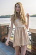 © rogkoff - Young beautiful blond woman in a beautiful dress on the waterfront