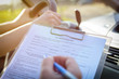 © Monika Wisniewska - Examiner filling in driver's license road test form
