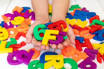 Child learning using magnetic letters and numbers