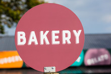 Bakery Word Maroon Disk Food Sign