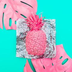 Poster - painted pink pineapple with tropical palm leaves on the holographic metal foil and green background. minimal and surreal. summer food