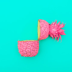 Poster - two painted in pink color halfs of the pineapple on turquoise background. minimalism and surrealism of food. flat lay