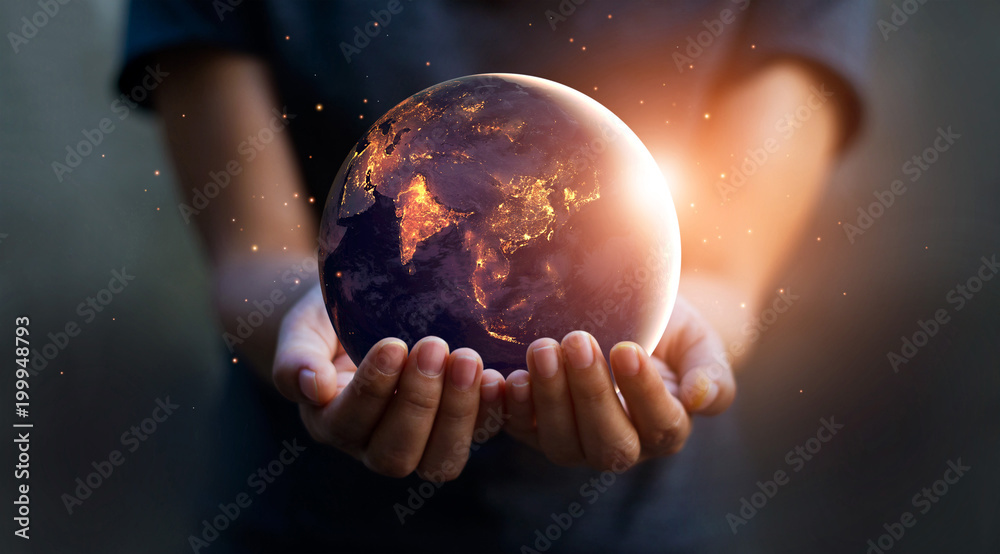 Earth at night was holding in human hands. Earth day. Energy saving concept, Elements of this image furnished by NASA - obrazy, fototapety, plakaty 