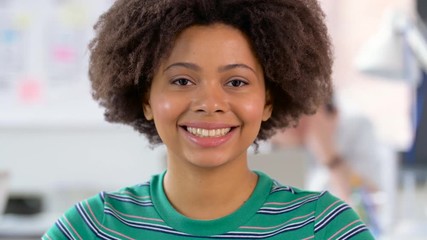 Poster - emotion, expression and people concept - portrait of happy smiling african american young woman at office