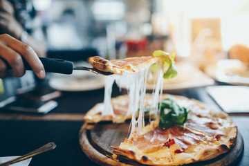 Homemade cheese pizza serve on wooden dish, hot and fresh food in the happy time.