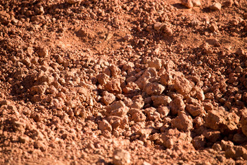 Wall Mural - Red clay soil on nature as a background