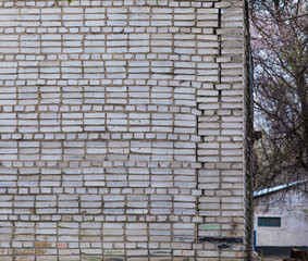 ancient weathered rough gray brick wall, old dirty abstract background