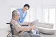 © Creativa Images - Female nurse talking with old man at home