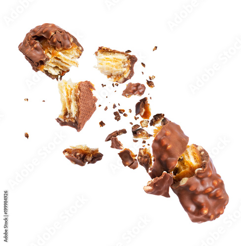 Fotomural Waffle chocolate bar with nuts broken into parts, isolated on white background