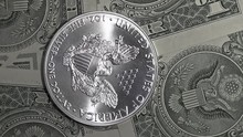 Silver Dollar Coin And One Dollar Bills Close Up