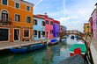Colorful houses along a canal with bridge on the island of Burano near Venice, Italy
