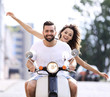 © ASDF - Happy young couple riding a scooter in the city on a sunny day