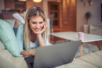 Poster - Beautiful woman at home working on laptop