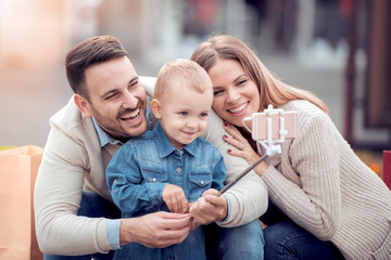 Wall Mural - Happy family having fun together,taking selfie