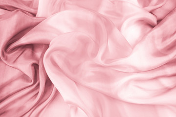 The texture of the satin fabric of pink color for the background  