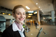 © Wavebreak Media - Portrait of smiling airline check-in attendant at counter