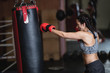 © Wavebreak Media - Female boxer practicing boxing with punching bag