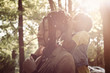 © Mladen - Young African American little girl making mom's hairstyle in the park.