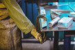 © Wavebreak Media - Mid-section of female welder using clamp tool