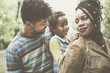 © Mladen - Happy African American family enjoying in park and mother holding daughter on piggyback.