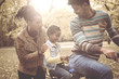 © Mladen - Cheerful African American Father driving daughter on bike.
