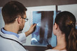 © Wavebreak Media - Physiotherapist explaining spine x-ray to female patient