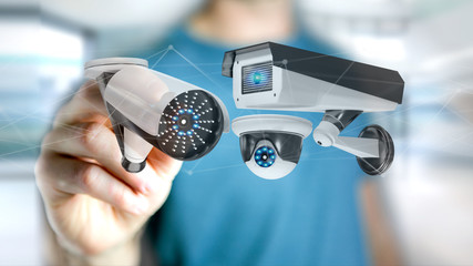 Poster - Businessman holding a Security camera system and network connection - 3d rendering