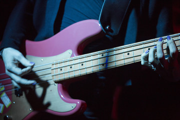 The hands of woman with electric bass