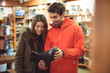 © Wavebreak Media - Couple selecting shoe in a shop