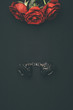 © LIGHTFIELD STUDIOS - Leather handcuffs with rose flowers isolated on black