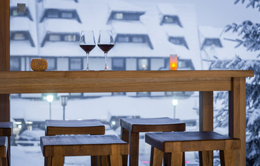 Wall Mural - winter holiday concept, two glass of wine on bar